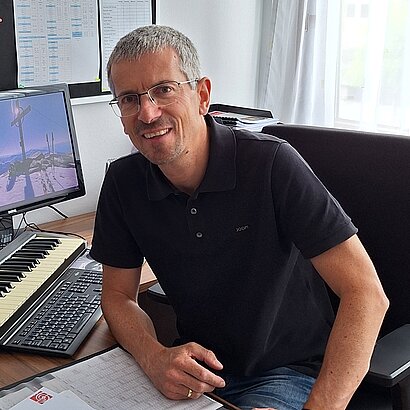 Portrait von Musikschuldirektor Günter Dibiasi an seinem Schreibtisch